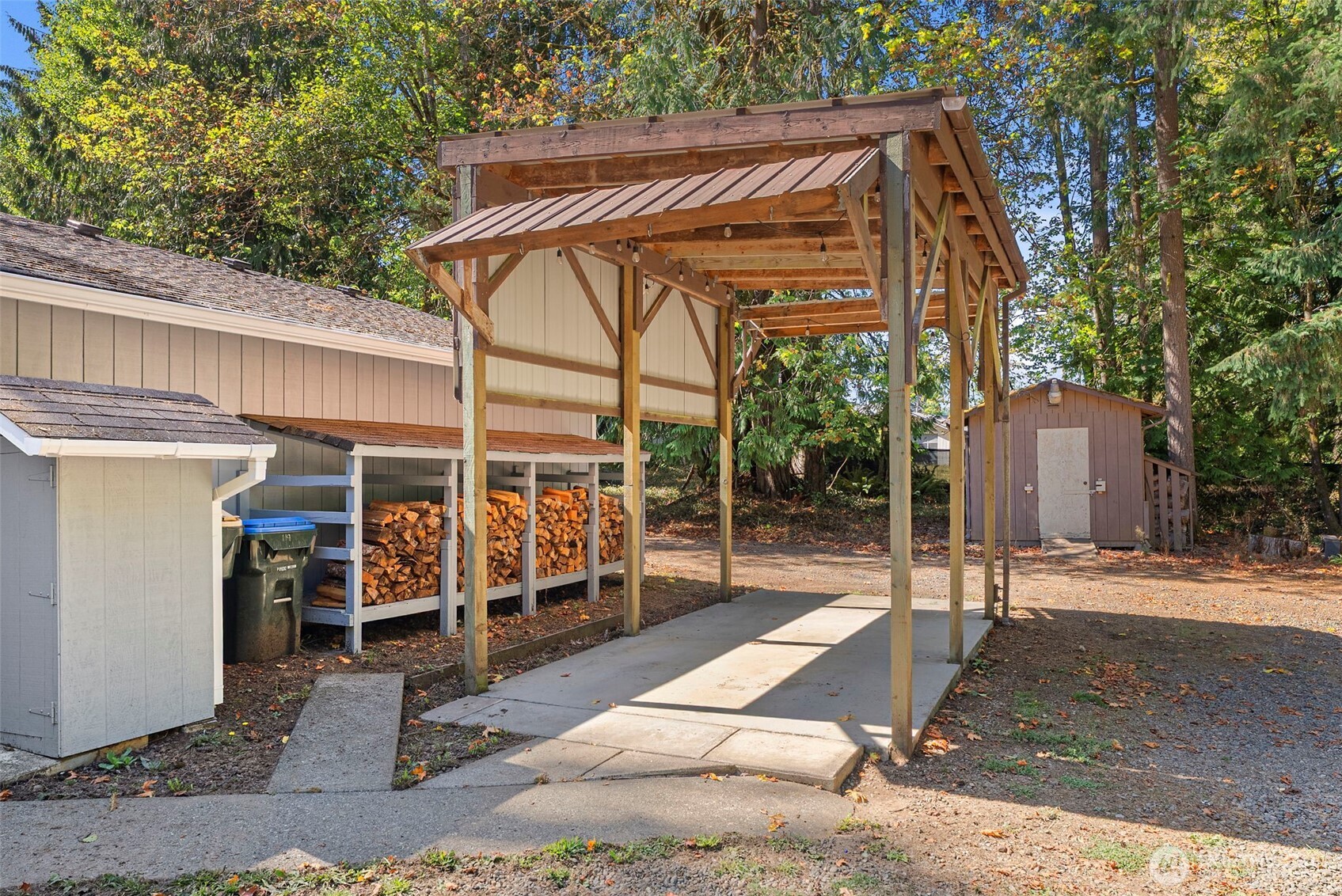 119 River Heights Road Centralia, WA 98531 - Photo 31 of 40 a view of a patio with table and chairs under an umbrella