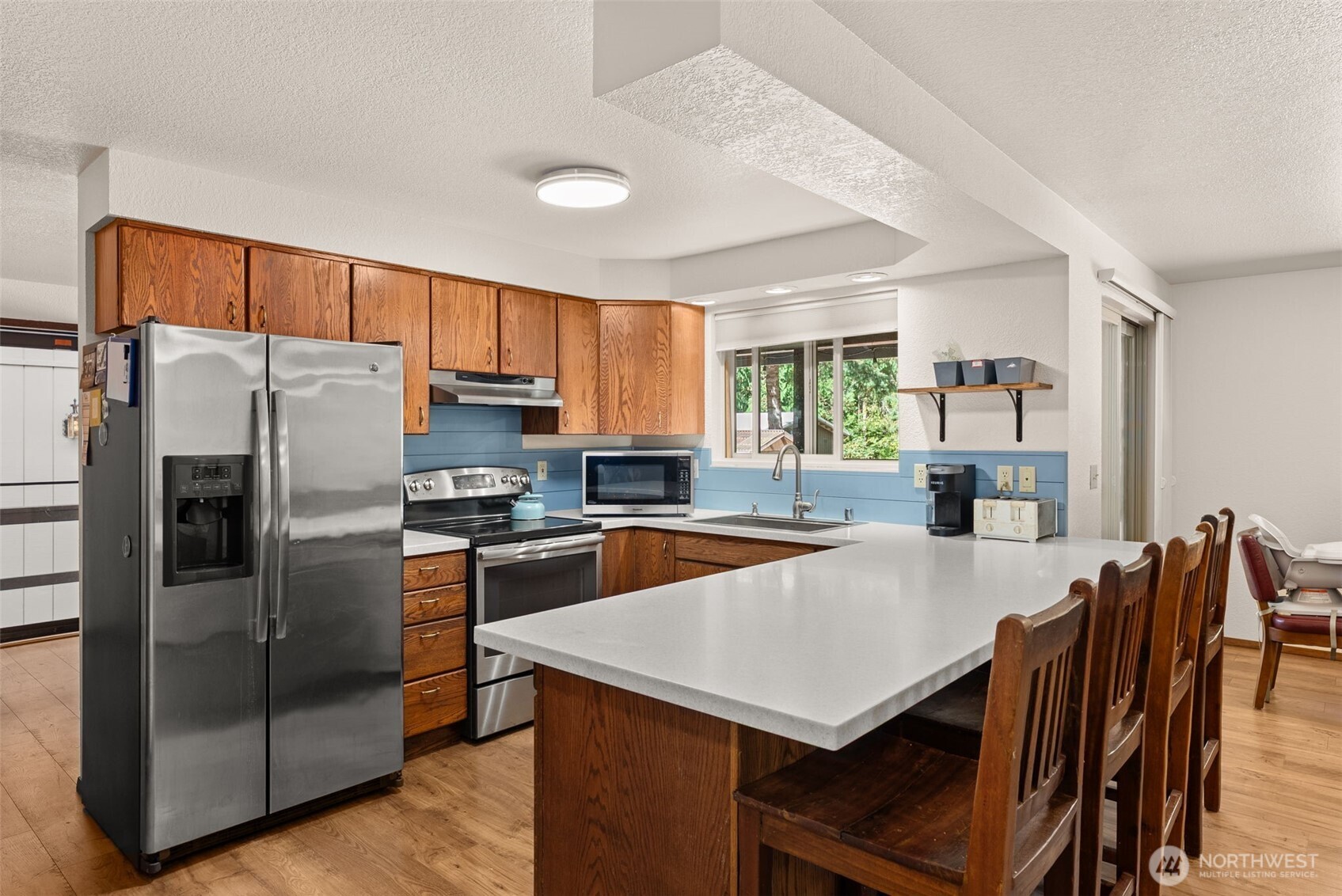 119 River Heights Road Centralia, WA 98531 - Photo 9 of 40 a kitchen with stainless steel appliances a refrigerator a stove a dining table and chairs