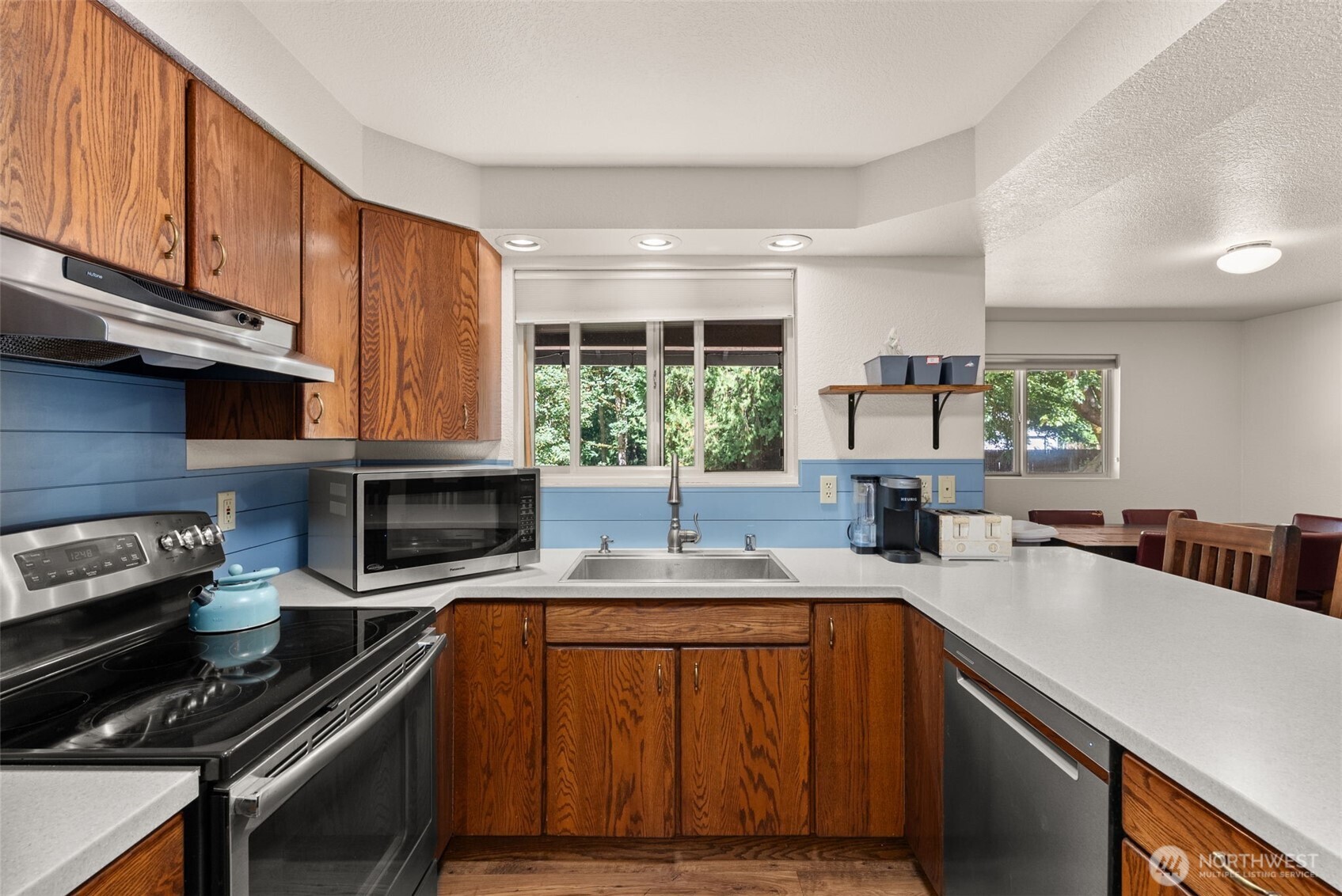 119 River Heights Road Centralia, WA 98531 - Photo 10 of 40 a kitchen with a stove a sink and a microwave