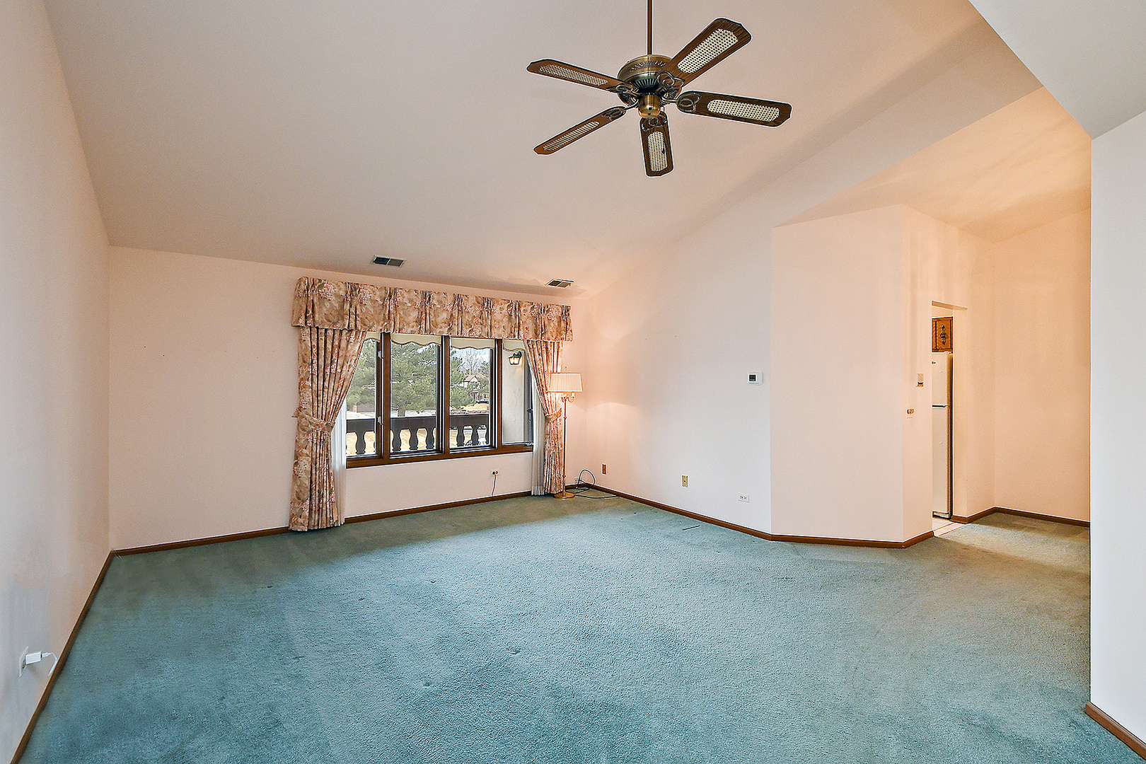 9722 West Creek Road, Unit E2 Palos Park, IL 60464 - Photo 4 of 18 an empty room with a window and a ceiling fan
