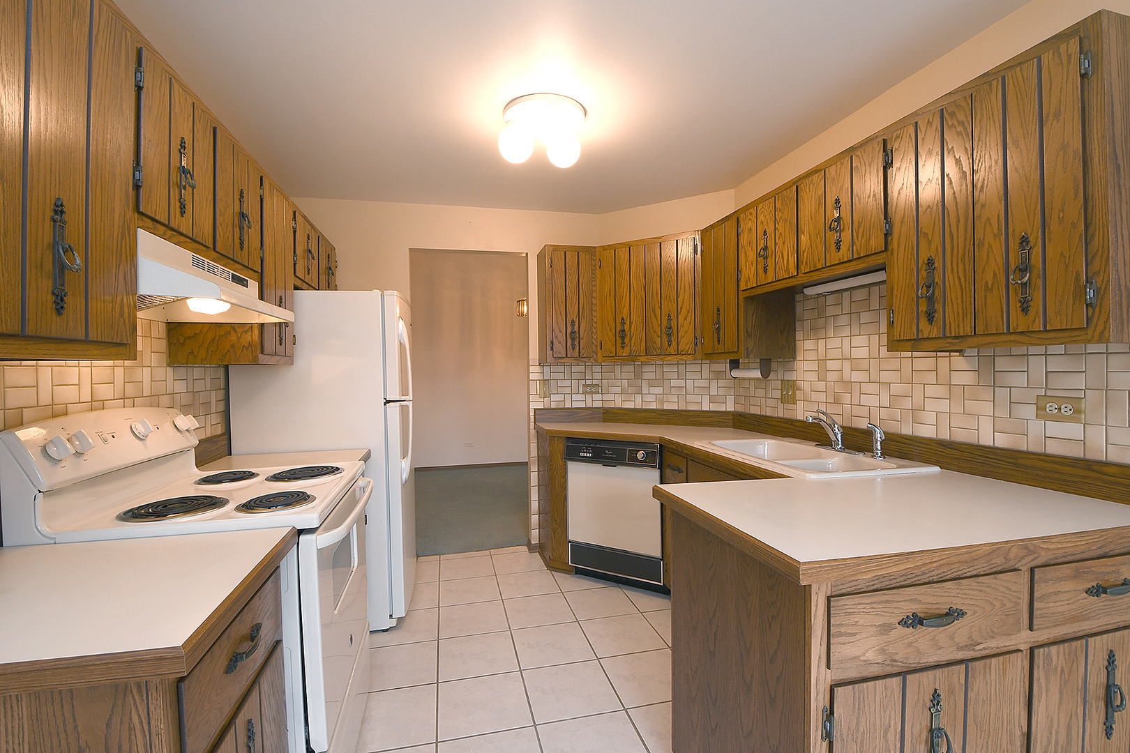 9722 West Creek Road, Unit E2 Palos Park, IL 60464 - Photo 8 of 18 a kitchen with a sink a stove and cabinets