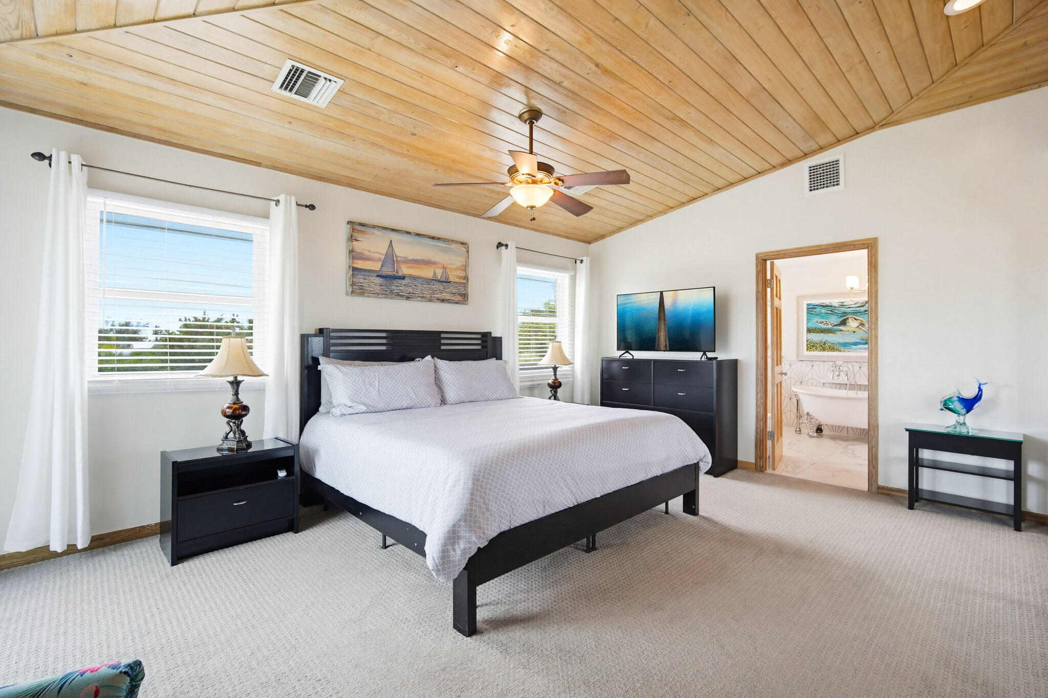 30463 Hawk Lane Big Pine Key, FL 33043 - Photo 29 of 64 a spacious bedroom with a bed and a chandelier