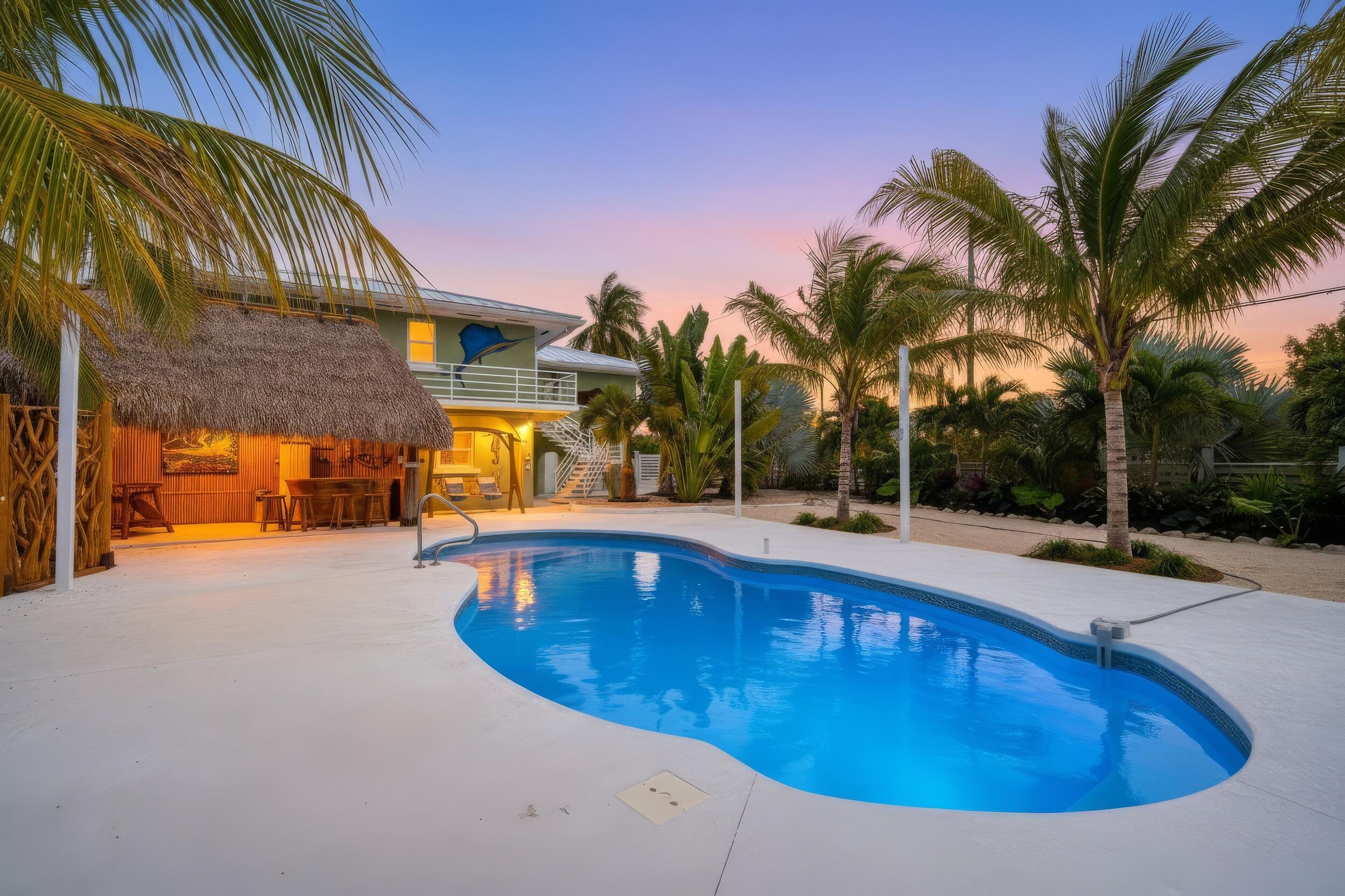 30463 Hawk Lane Big Pine Key, FL 33043 - Photo 3 of 64 a view of a swimming pool with a lounge chair