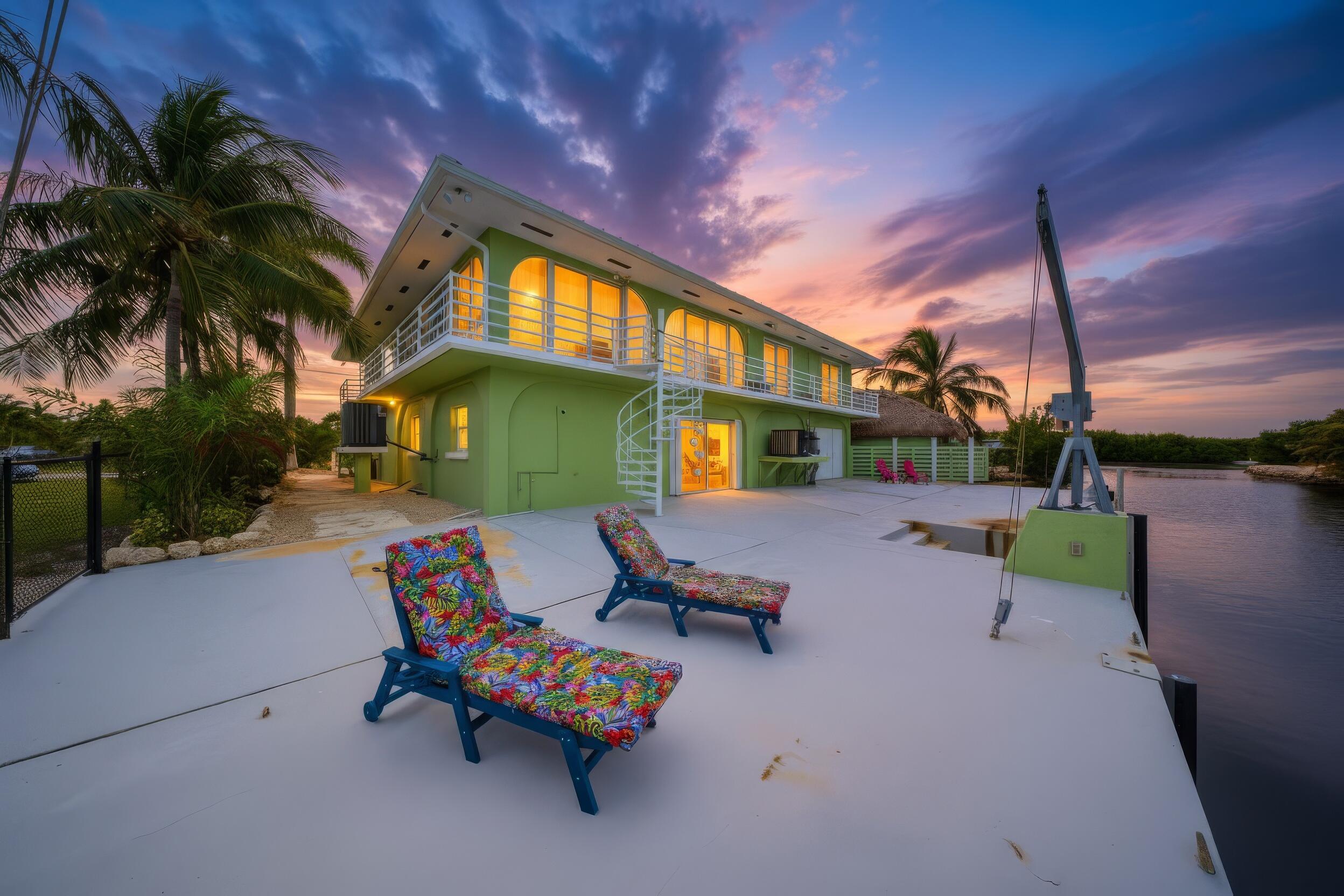 30463 Hawk Lane Big Pine Key, FL 33043 - Photo 54 of 64 a backyard of a house with table and chairs