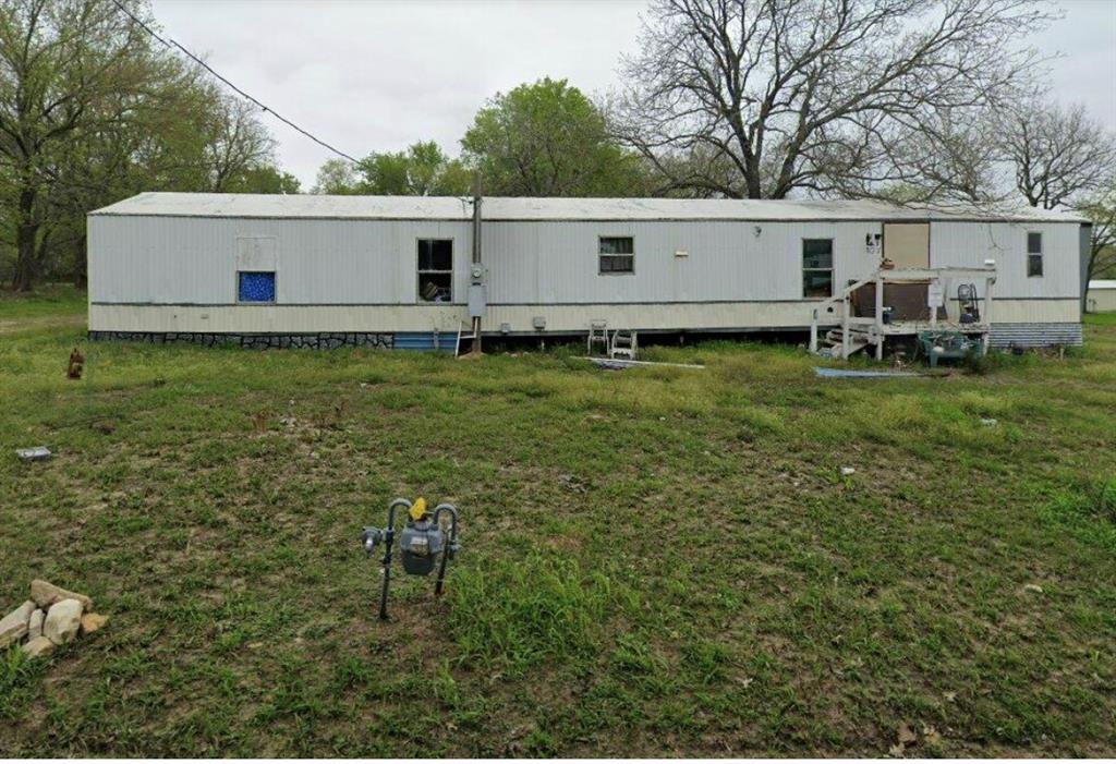 107 Red Bud Street Ravenna, TX 75476 - Photo 1 of 1 a view of a back yard of the house with green space