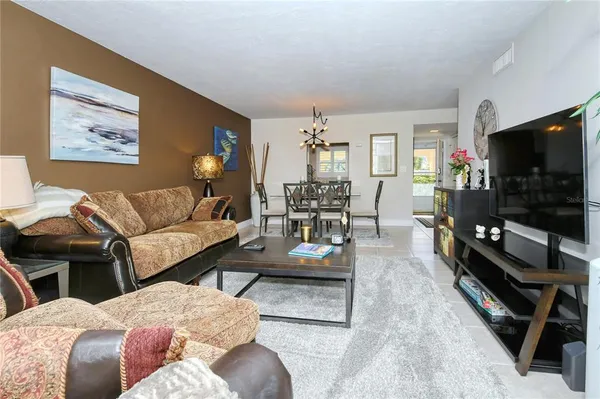 a view of a dining room with furniture and a chandelier