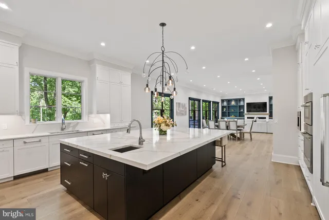 a view of a dining room and a kitchen with a dining table chairs