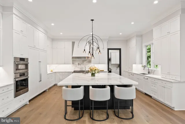 a view of a dining room and a kitchen with a dining table chairs