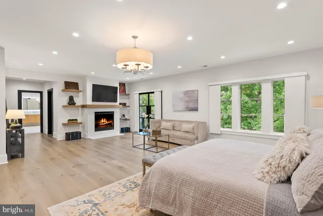 a spacious bathroom with a double vanity sink a large mirror and a bathtub