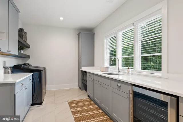 a living room with patio furniture and a chandelier