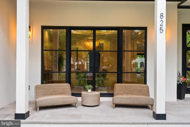 a living room with furniture and floor to ceiling window