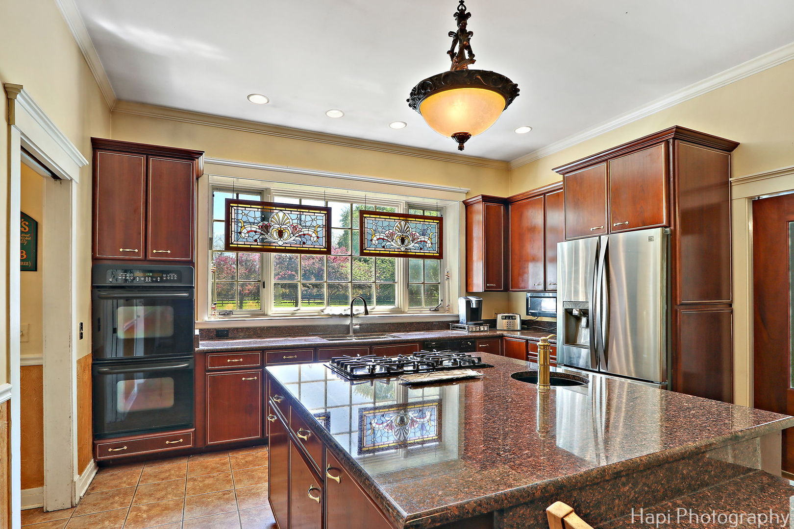 23 West County Line Road Barrington Hills, IL 60010 - Photo 18 of 71 a kitchen with stainless steel appliances granite countertop a stove and a refrigerator