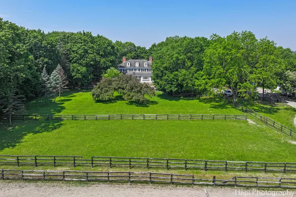 an aerial view of a house with a garden and trees