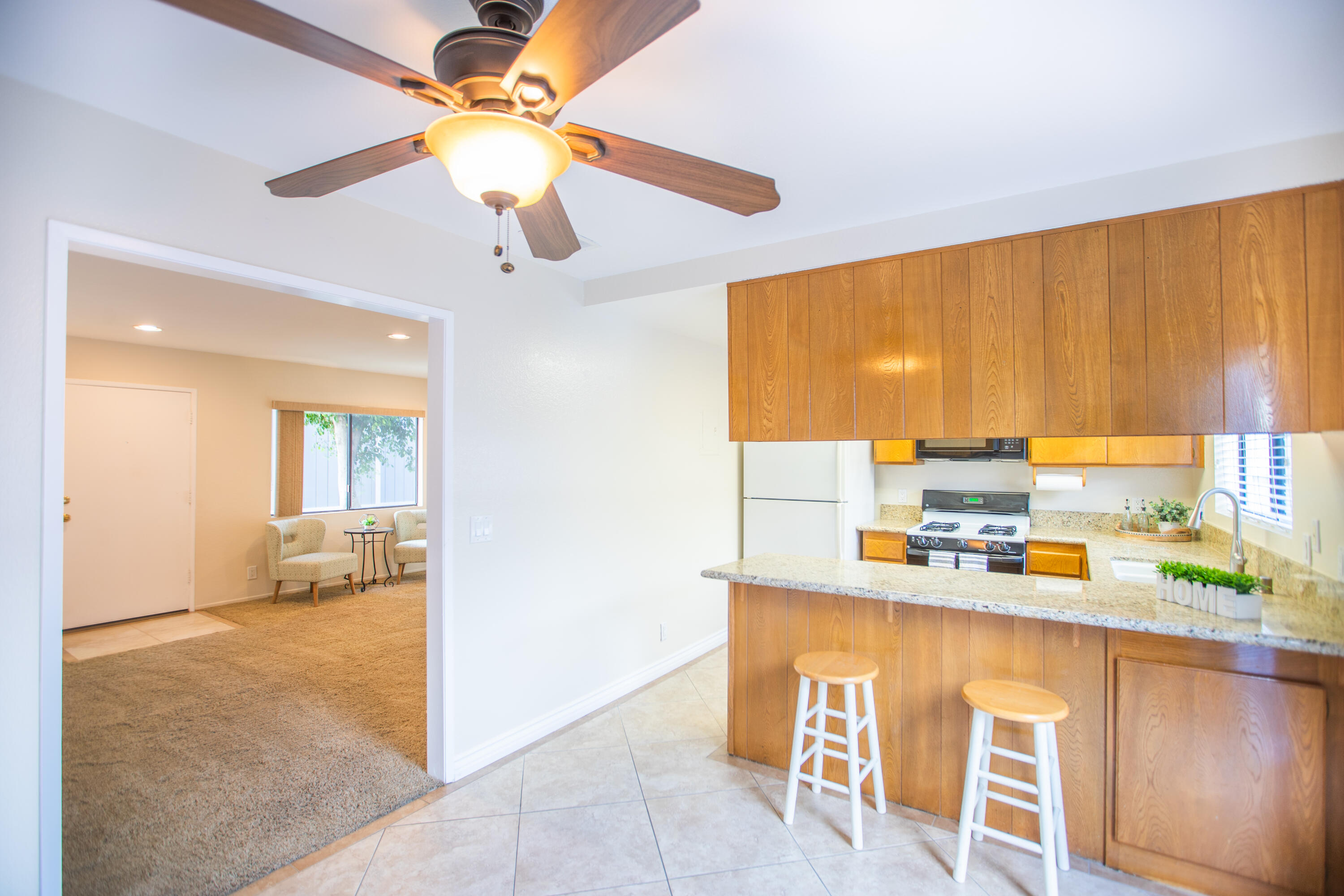 15261 Leffingwell Road, Unit 3 Whittier, CA 90604 - Photo 1 of 33 a kitchen with a table chairs and a refrigerator