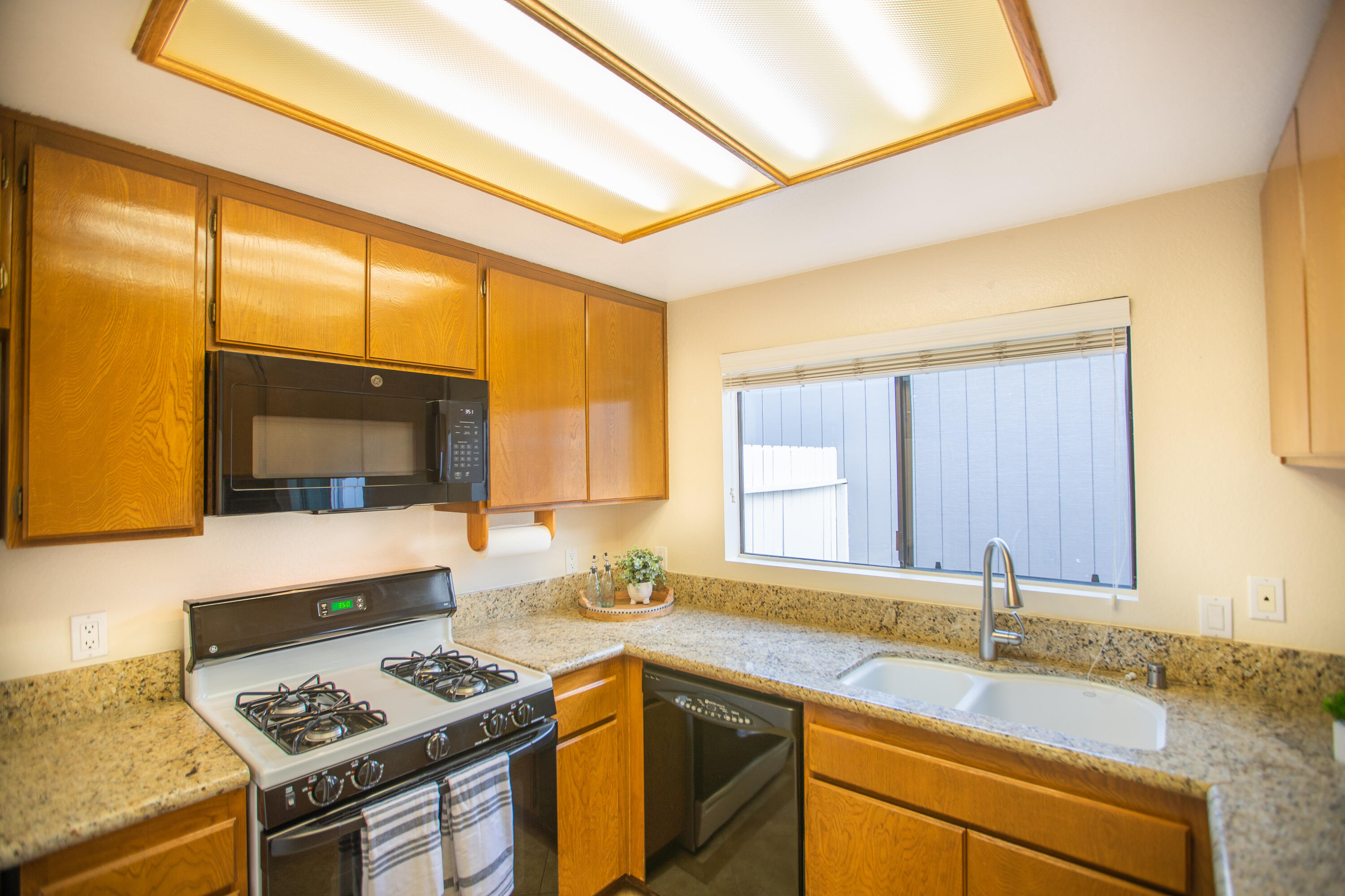 15261 Leffingwell Road, Unit 3 Whittier, CA 90604 - Photo 11 of 33 a kitchen with stainless steel appliances granite countertop a sink stove and cabinets