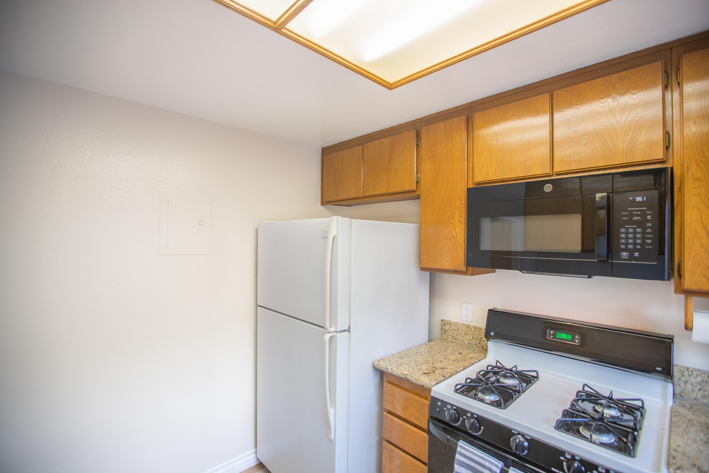 15261 Leffingwell Road, Unit 3 Whittier, CA 90604 - Photo 12 of 33 a kitchen with a stove a refrigerator and a microwave