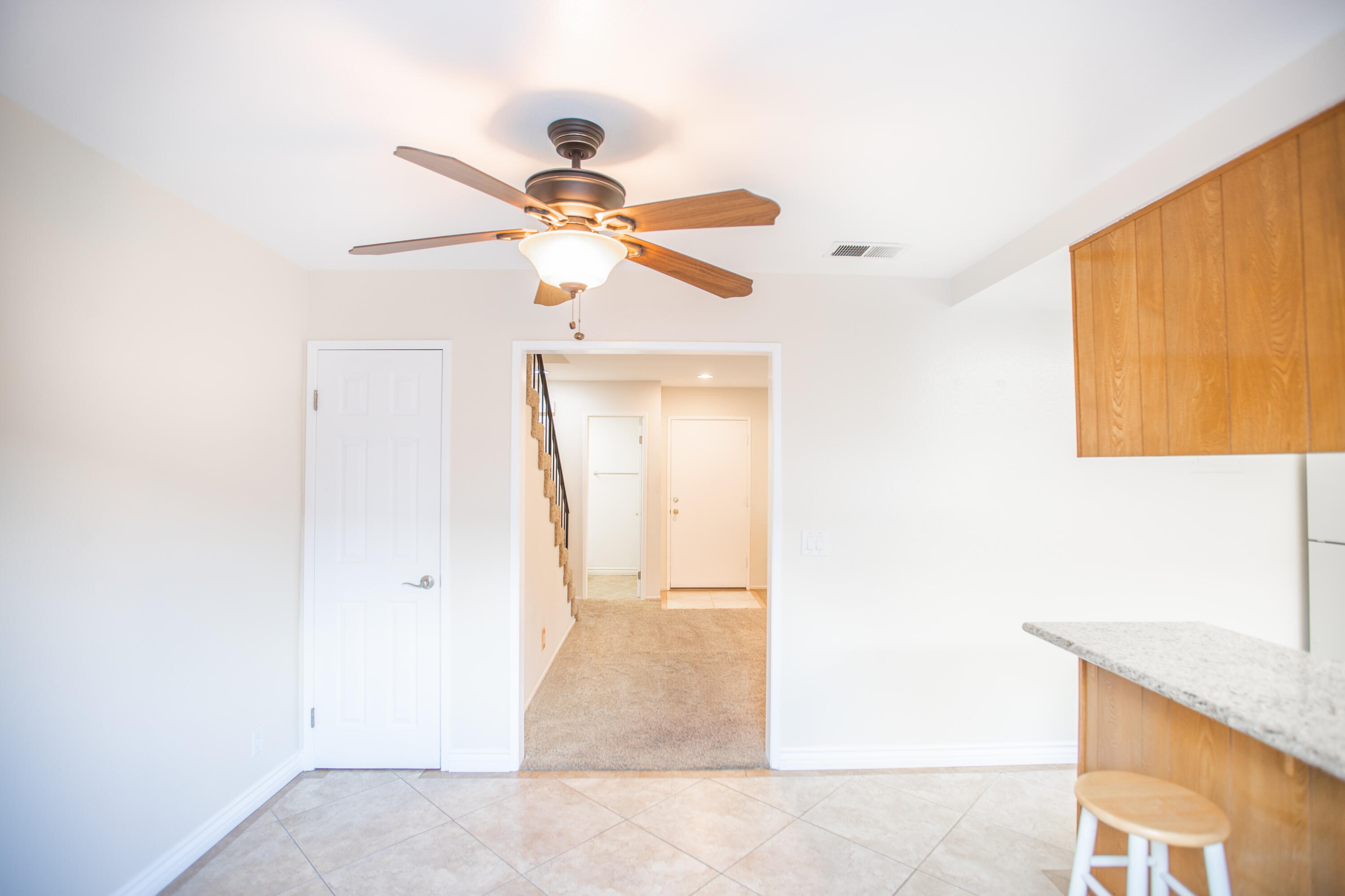 15261 Leffingwell Road, Unit 3 Whittier, CA 90604 - Photo 13 of 33 a view of a hallway with a chandelier fan and a bathroom