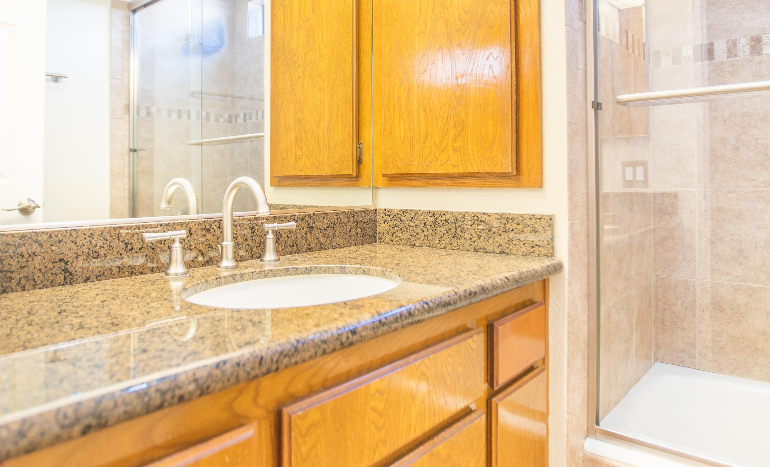 15261 Leffingwell Road, Unit 3 Whittier, CA 90604 - Photo 21 of 33 a bathroom with a granite countertop sink and a mirror