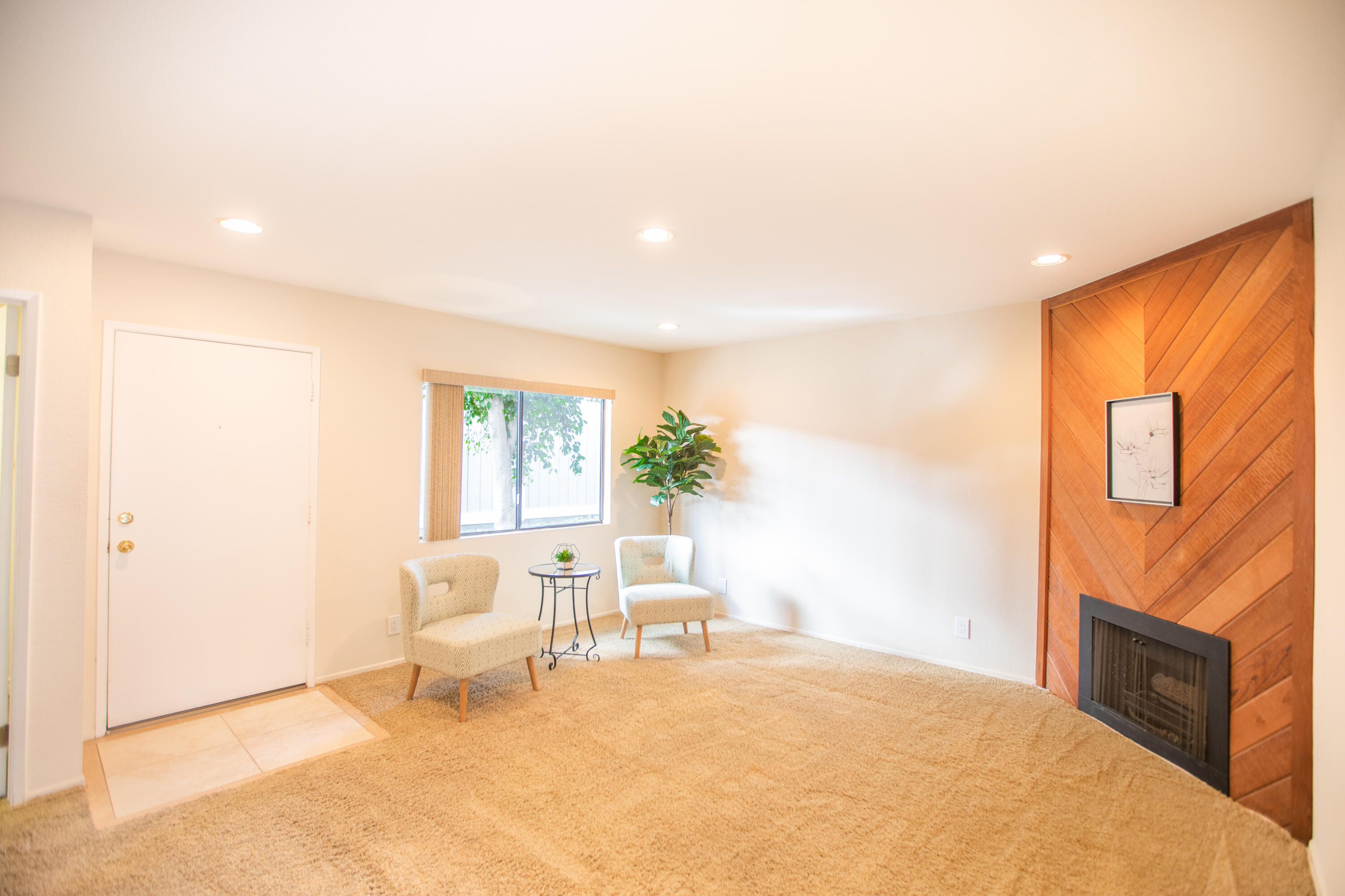 15261 Leffingwell Road, Unit 3 Whittier, CA 90604 - Photo 3 of 33 a living room with furniture a fireplace and a flat screen tv