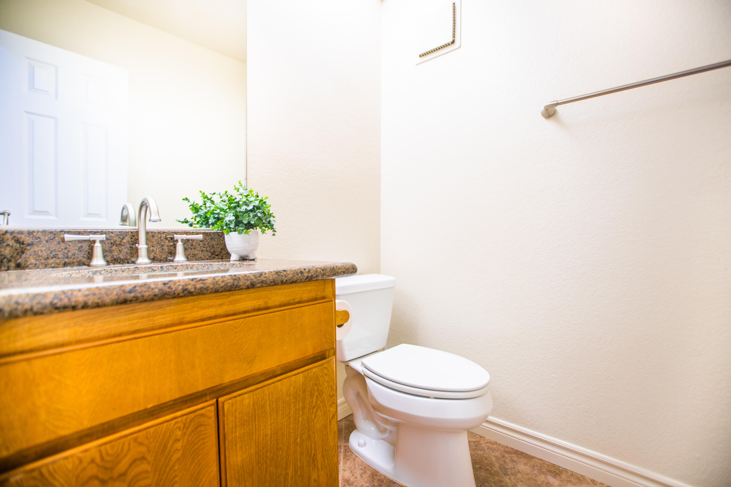 15261 Leffingwell Road, Unit 3 Whittier, CA 90604 - Photo 5 of 33 a bathroom with a granite countertop sink mirror vanity and toilet