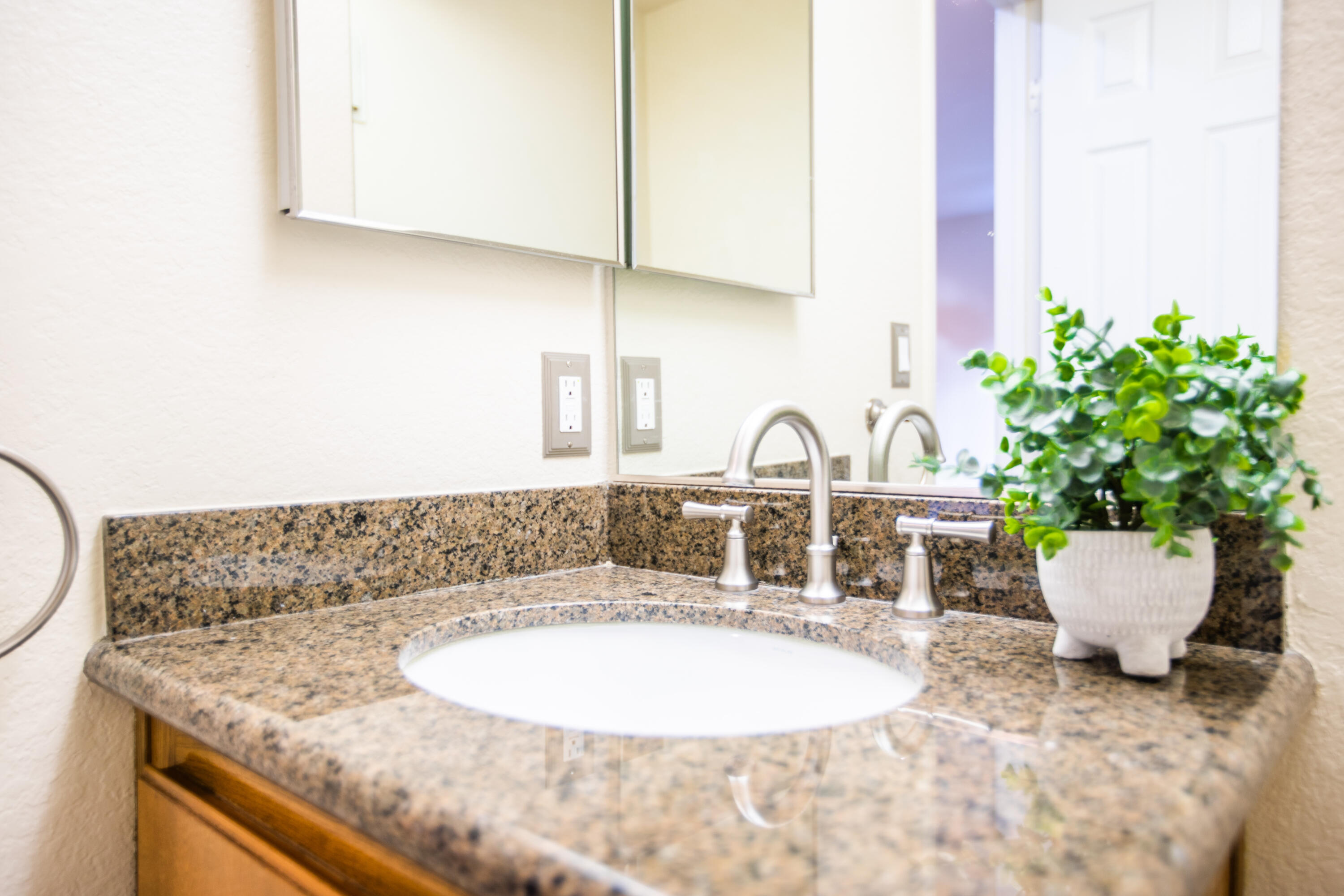 15261 Leffingwell Road, Unit 3 Whittier, CA 90604 - Photo 7 of 33 a bathroom with a granite countertop sink and a mirror