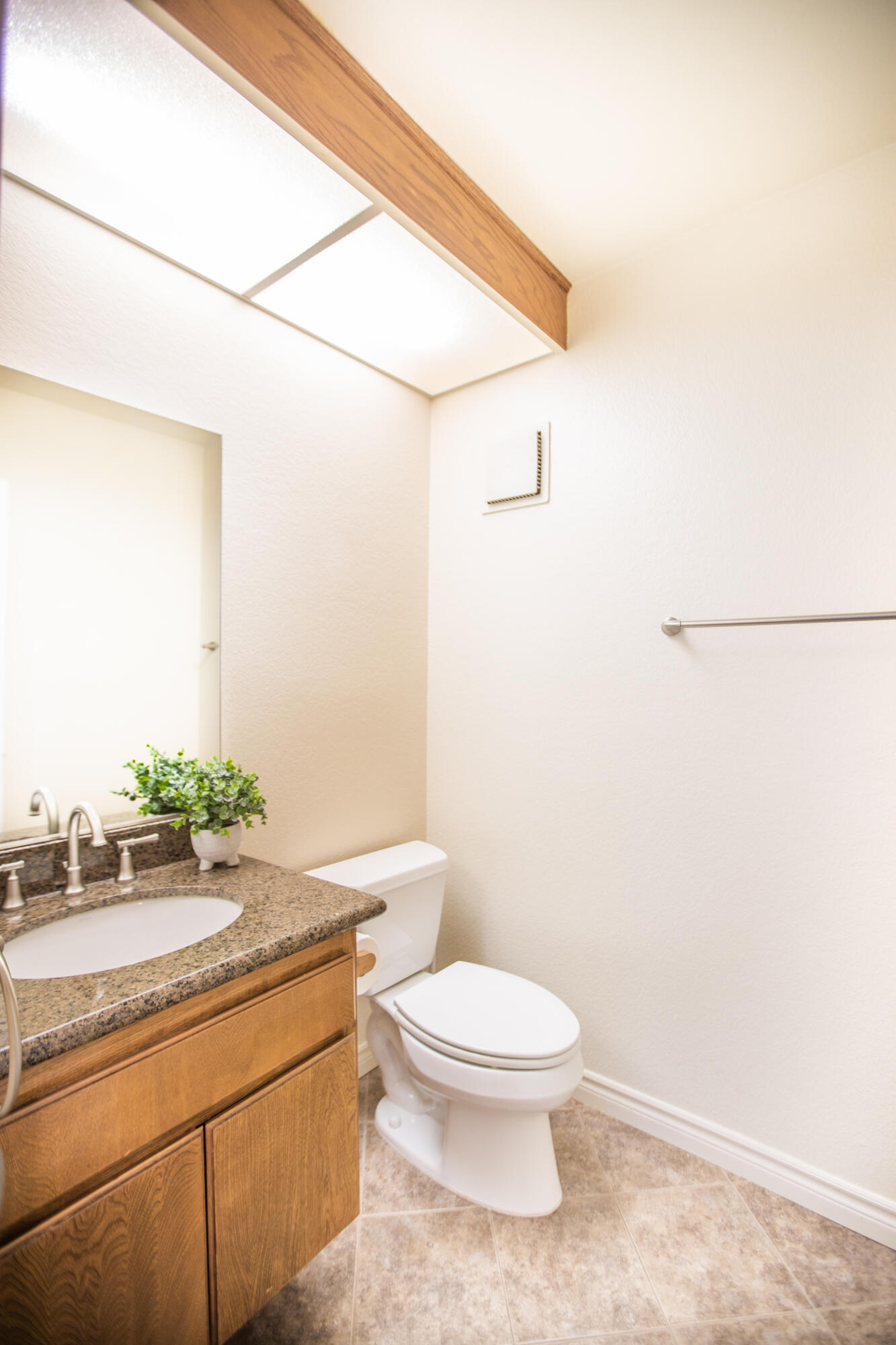 15261 Leffingwell Road, Unit 3 Whittier, CA 90604 - Photo 8 of 33 a bathroom with a granite countertop sink a toilet and mirror