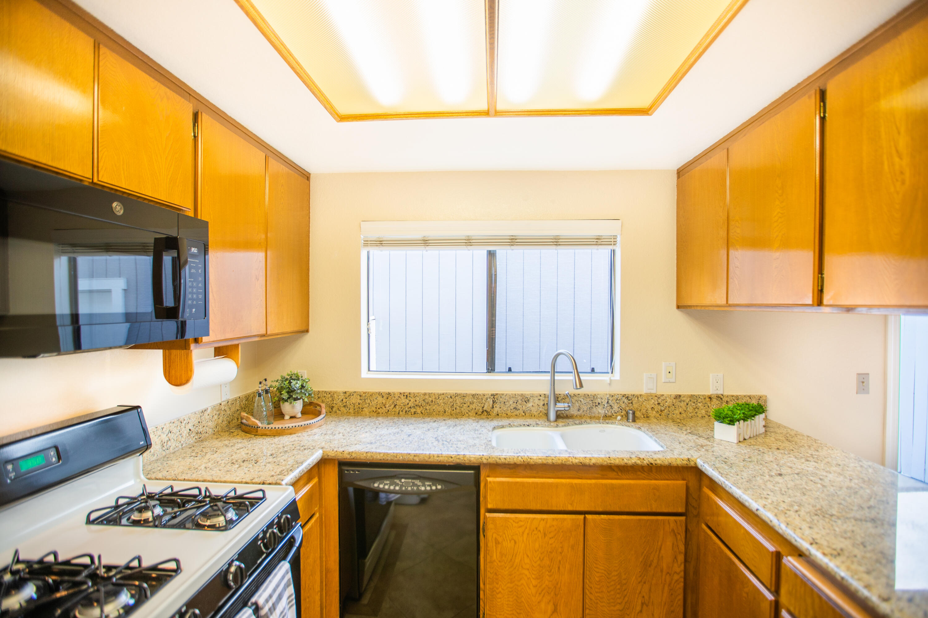 15261 Leffingwell Road, Unit 3 Whittier, CA 90604 - Photo 10 of 33 a kitchen with a sink and a stove next to a window