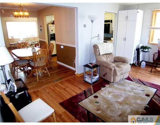 173 Midfield Road Colonia, NJ 07067 - Photo 12 of 25 a living room with furniture and a large mirror