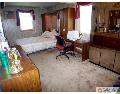 173 Midfield Road Colonia, NJ 07067 - Photo 13 of 25 a bedroom with furniture and a window