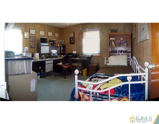 173 Midfield Road Colonia, NJ 07067 - Photo 14 of 25 a living room with furniture and a flat screen tv