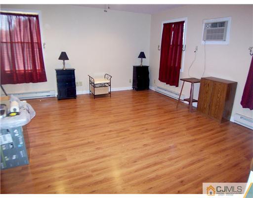 173 Midfield Road Colonia, NJ 07067 - Photo 15 of 25 a view of a livingroom with furniture and wooden floor
