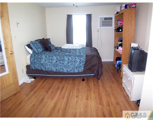 173 Midfield Road Colonia, NJ 07067 - Photo 17 of 25 a living room with furniture and a wooden floor