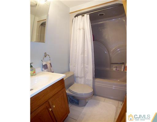 173 Midfield Road Colonia, NJ 07067 - Photo 18 of 25 a bathroom with a sink a toilet and shower