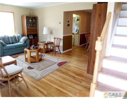 173 Midfield Road Colonia, NJ 07067 - Photo 3 of 25 a living room with furniture and wooden floor