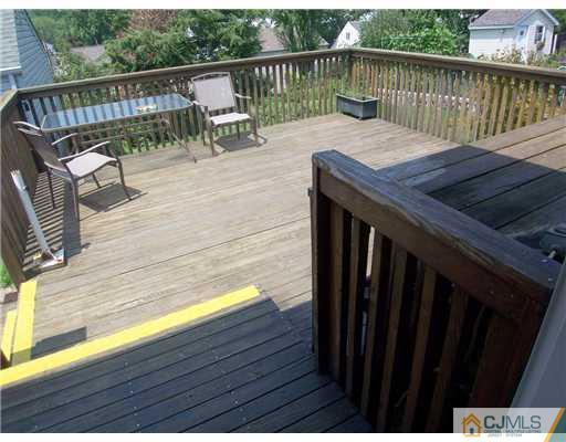 173 Midfield Road Colonia, NJ 07067 - Photo 22 of 25 a balcony with wooden floor table and chairs