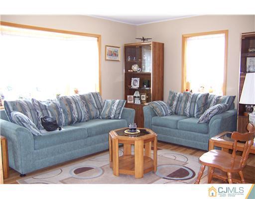 173 Midfield Road Colonia, NJ 07067 - Photo 4 of 25 a living room with furniture and a large window