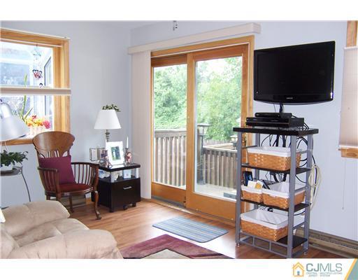 173 Midfield Road Colonia, NJ 07067 - Photo 10 of 25 a living room with furniture a flat screen tv and a window