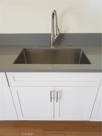 a kitchen with a sink a stove and cabinets