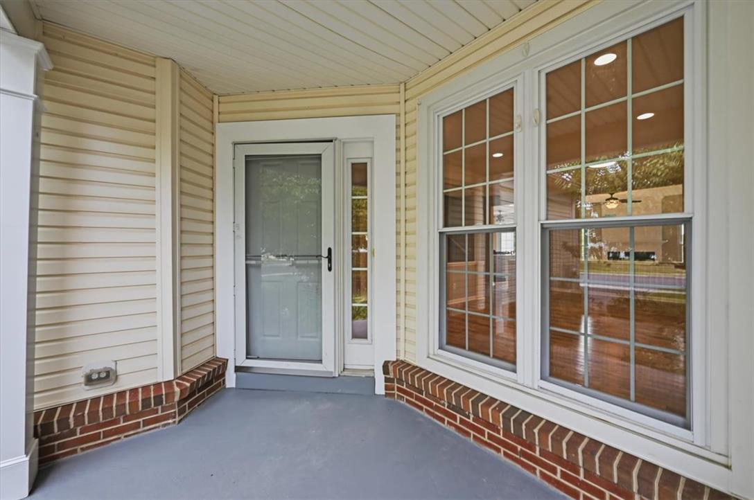 8761 Cascade Road Breinigsville, PA 18031 - Photo 2 of 84 A welcoming covered front porch, featuring brickwork and siding, creates an inviting entryway.