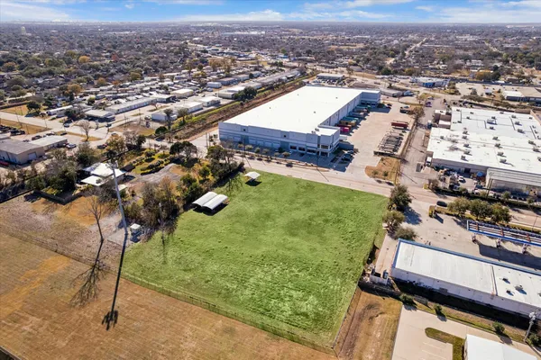 an aerial view of residential houses with outdoor space and parking