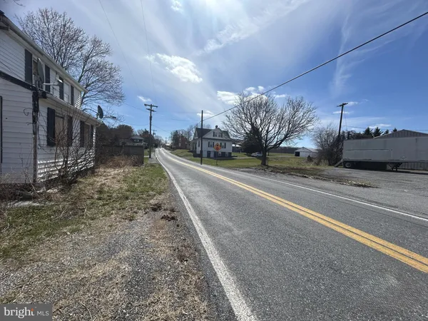 a view of a road with a building in the background