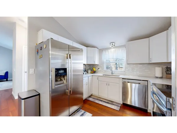 a kitchen with stainless steel appliances a refrigerator and cabinets