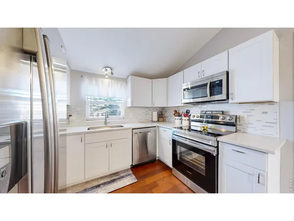 a kitchen with sink cabinets and stainless steel appliances