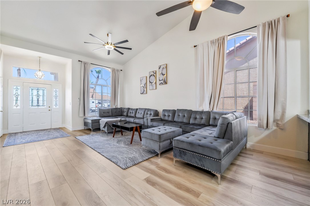 104 Appian Way Henderson, NV 89002 - Photo 3 of 24 Vast living space with soaring vaulted ceilings and bright wood flooring awaits.