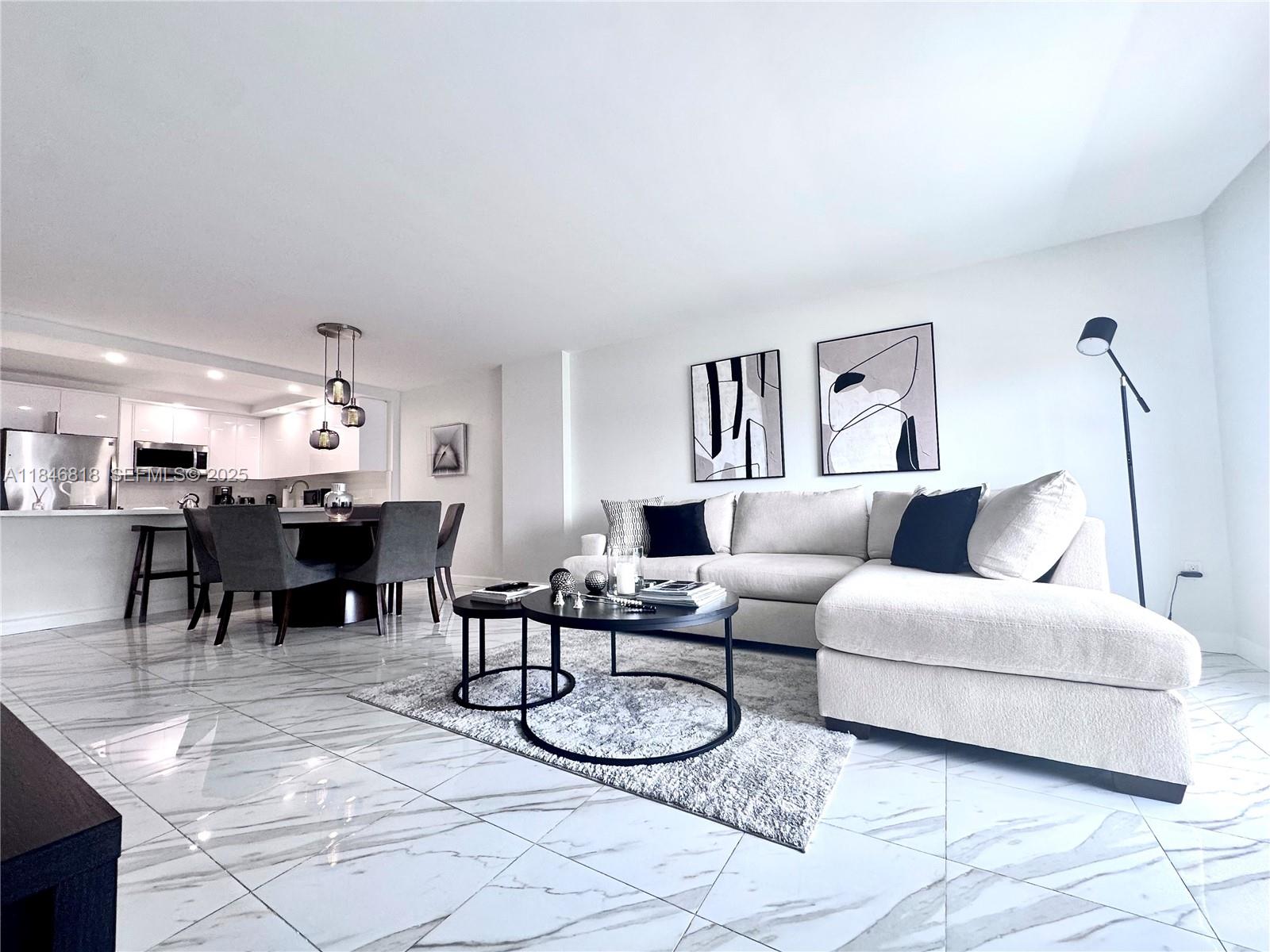 a living room with furniture a dining table and chairs