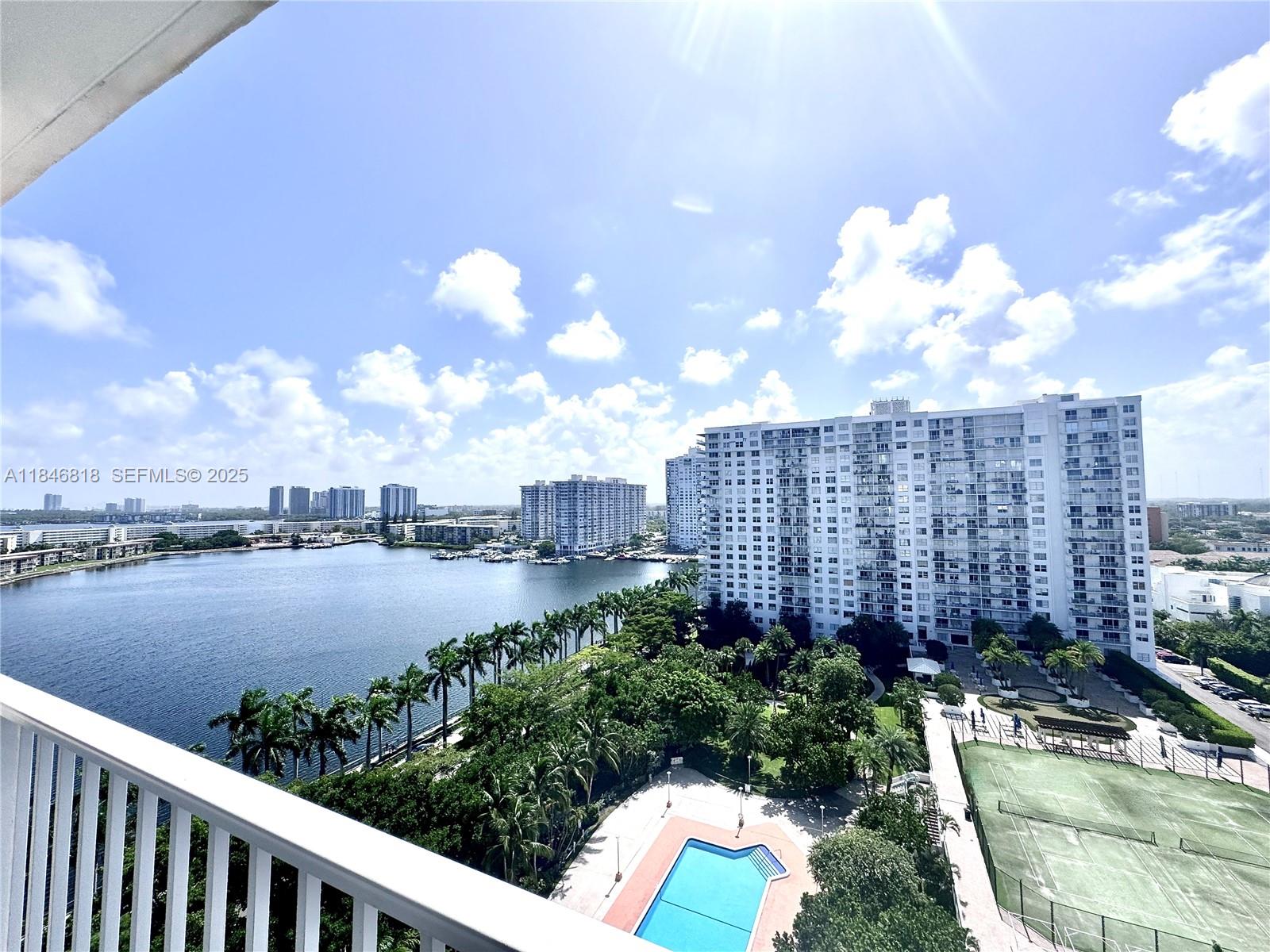 2851 Northeast 183rd Street, Unit 1508E Aventura, FL 33160 - Photo 2 of 27 a view of a lake and a yard