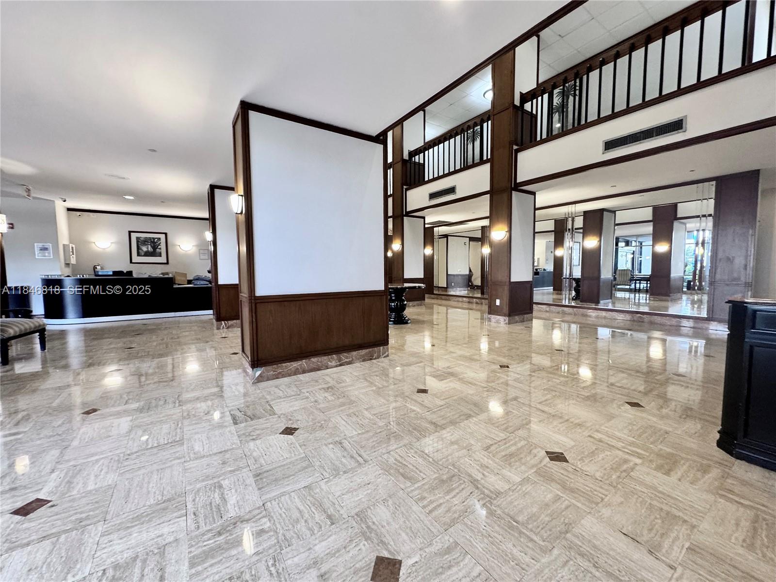 2851 Northeast 183rd Street, Unit 1508E Aventura, FL 33160 - Photo 21 of 27 a lobby with furniture and a rug