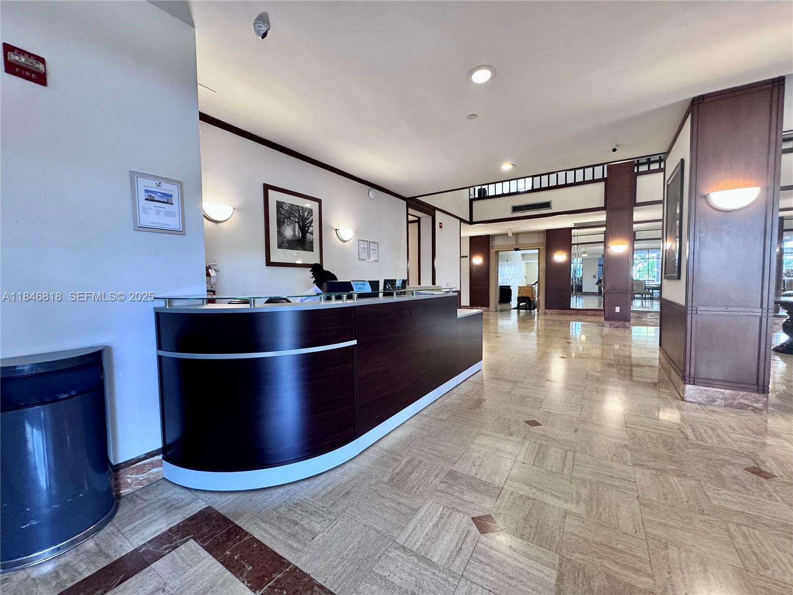 2851 Northeast 183rd Street, Unit 1508E Aventura, FL 33160 - Photo 22 of 27 a kitchen with stainless steel appliances kitchen island granite countertop a sink and cabinets