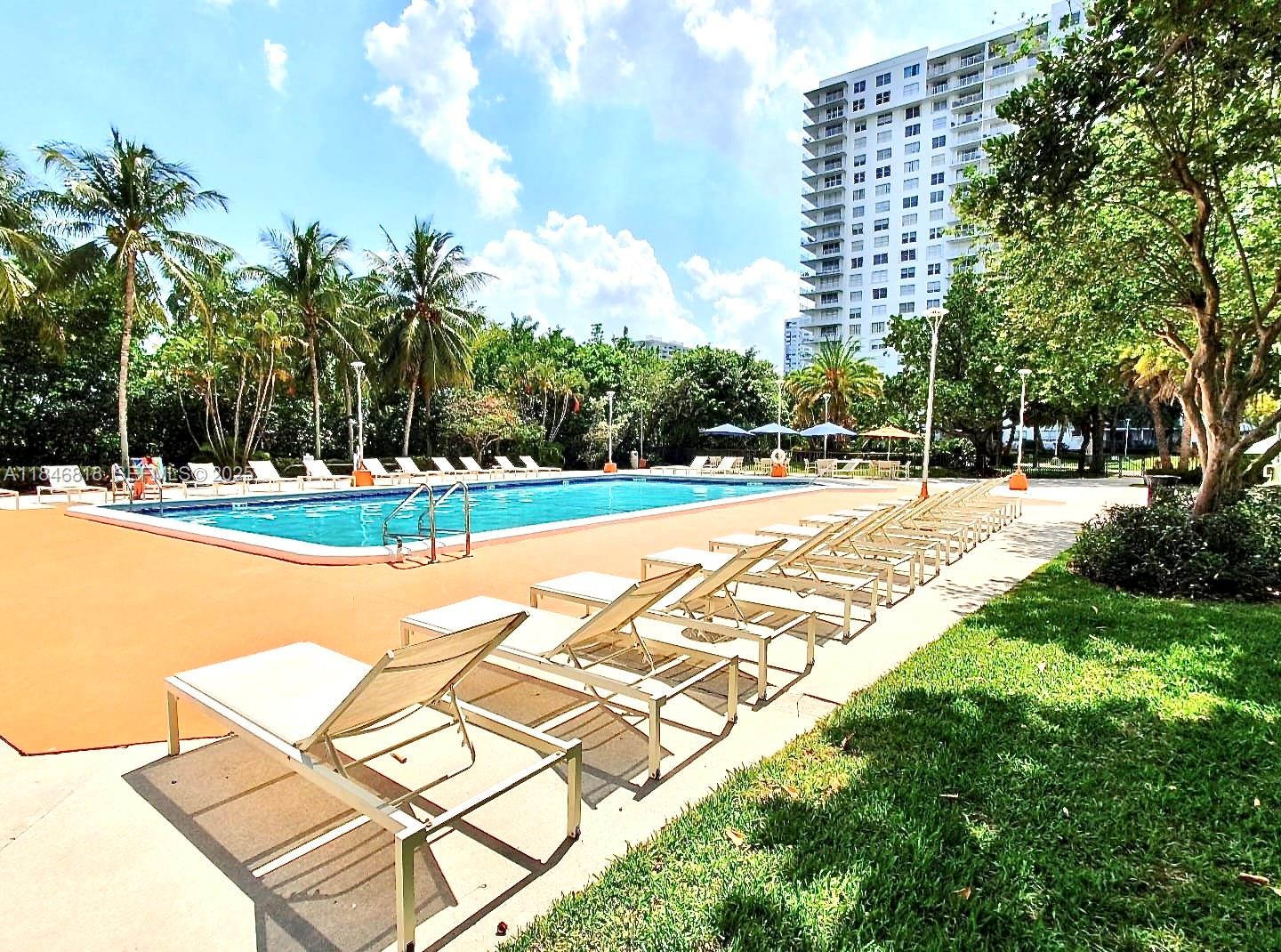 2851 Northeast 183rd Street, Unit 1508E Aventura, FL 33160 - Photo 25 of 27 a view of swimming pool with outdoor seating and plants