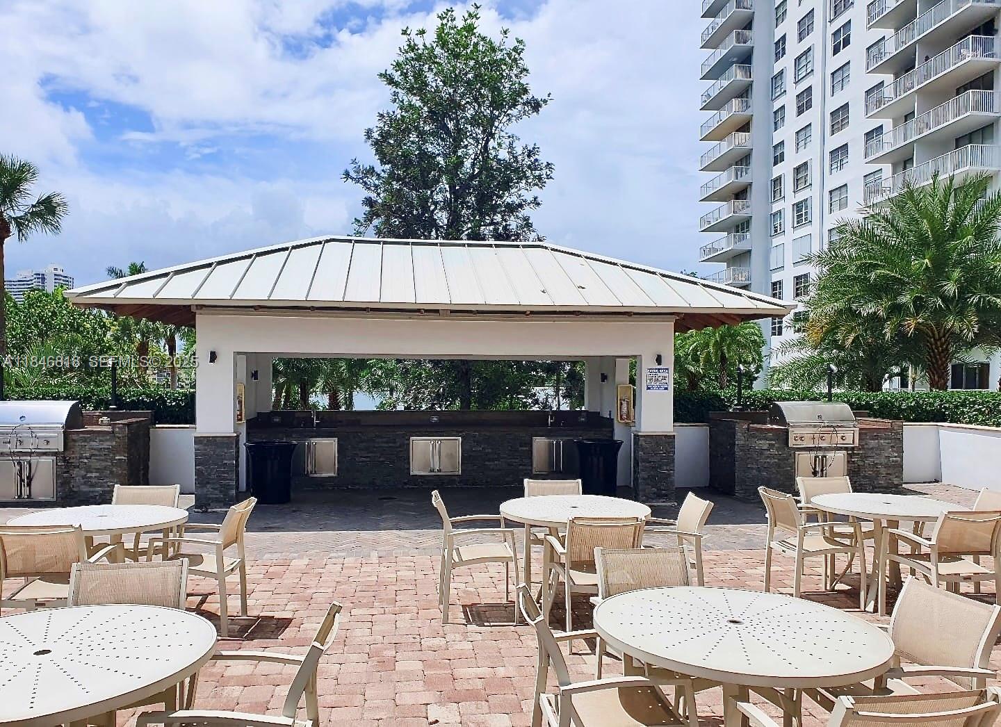 2851 Northeast 183rd Street, Unit 1508E Aventura, FL 33160 - Photo 26 of 27 a patio with table and chairs